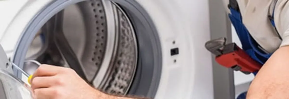 Appliance technician repairing a clothes dryer drum and internal parts in Glendale, AZ